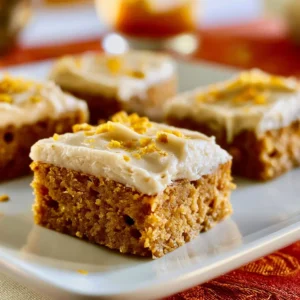 Easy pumpkin bars topped with maple cream, a perfect fall dessert.